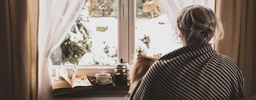 Life Assure Cold Senior Keeping Warm With Blanket And Dog Hero